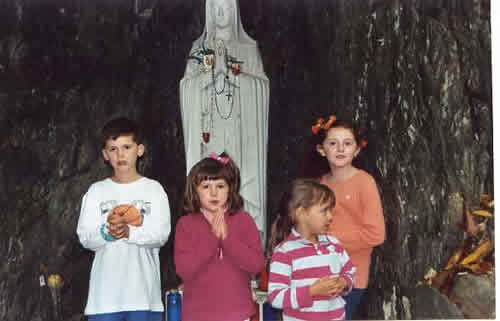 Catie, Maggie, Max, and Mia in front of the replica Lourdes grotto at Malvern on the family retreat.  Years later, we would all visit the real Lourdes grotto as we prepared Catie for eternal life 